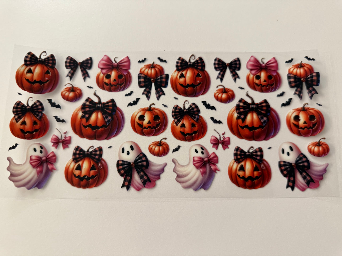 Ghost and pumpkins with bows